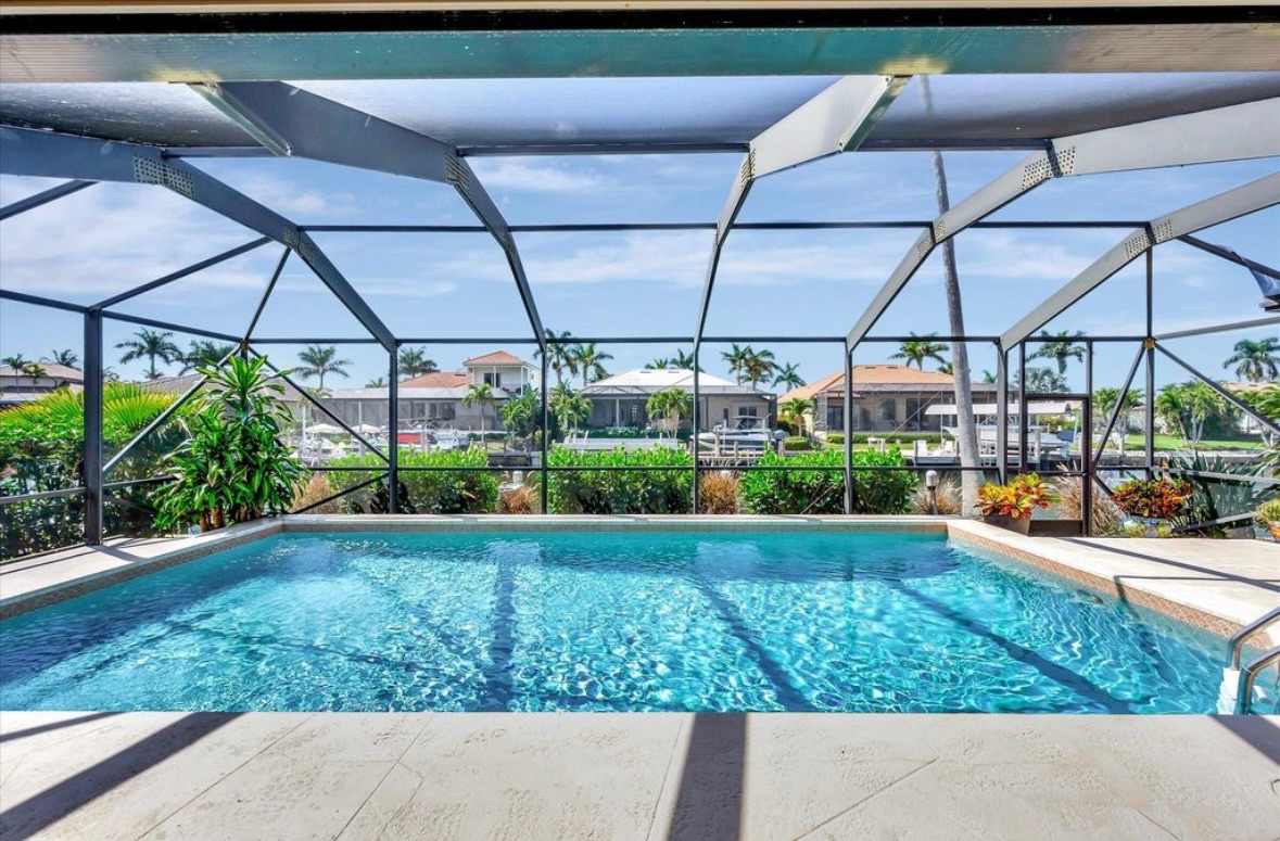 Heated saltwater pool under the screened lanai at Pirates Cove Marco Island