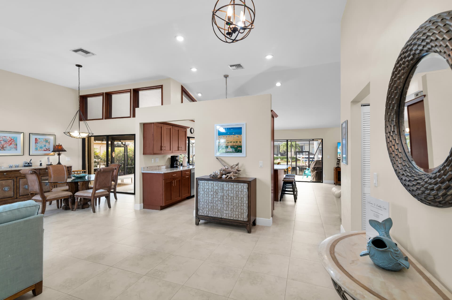 Open-plan dining and kitchen with pool view at Pirates Cove Marco Island