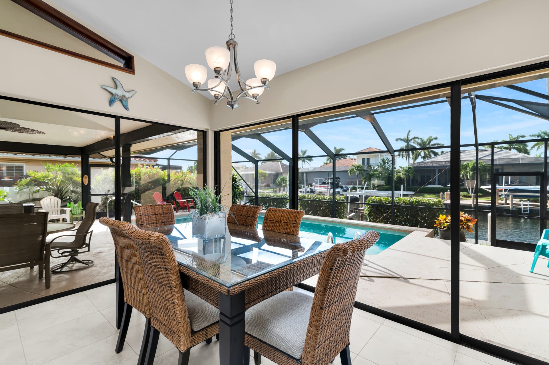 Lanai dining table overlooking the pool and canal at Pirates Cove Marco Island