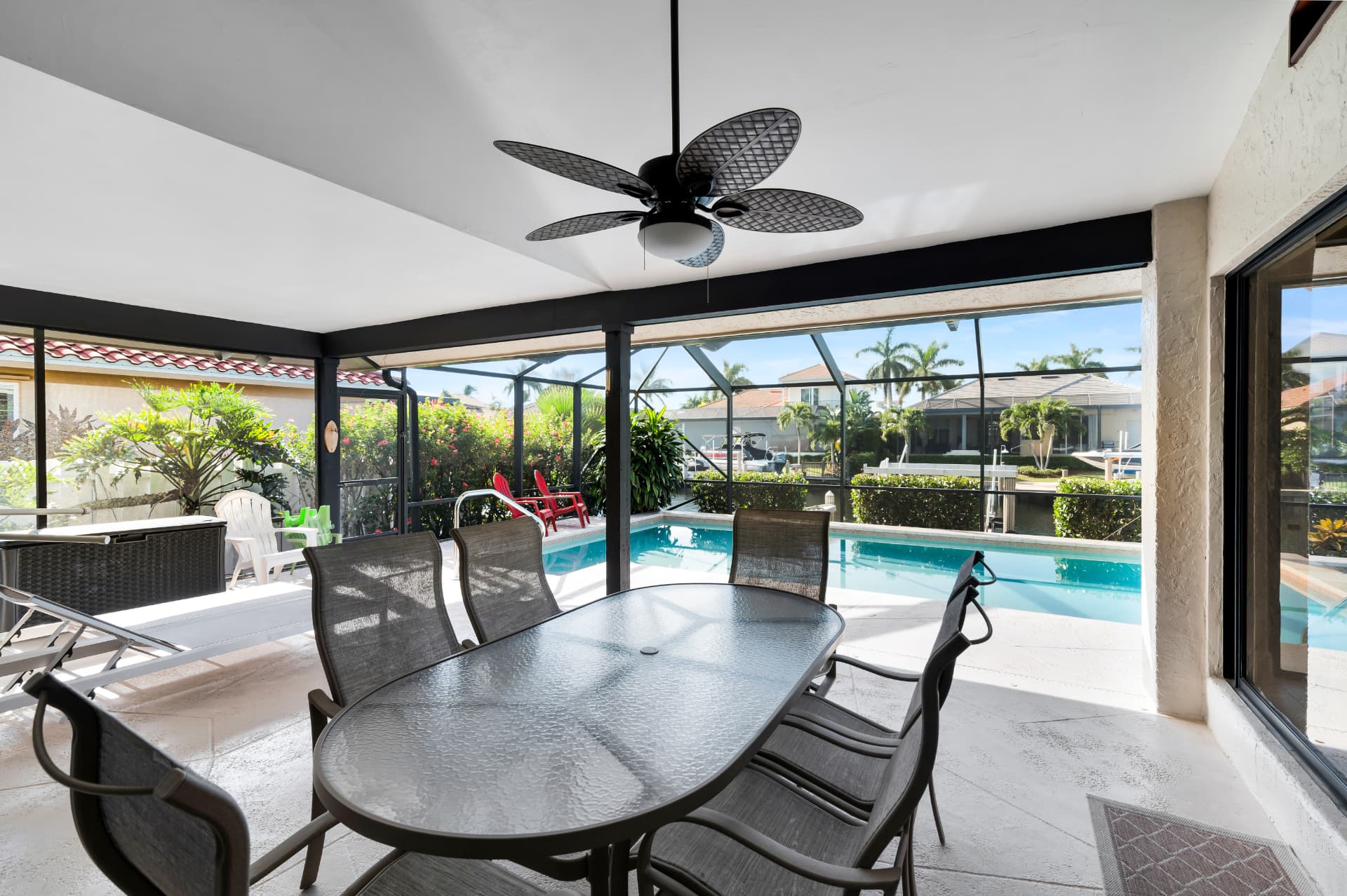 Covered patio seating beside the pool at Pirates Cove Marco Island