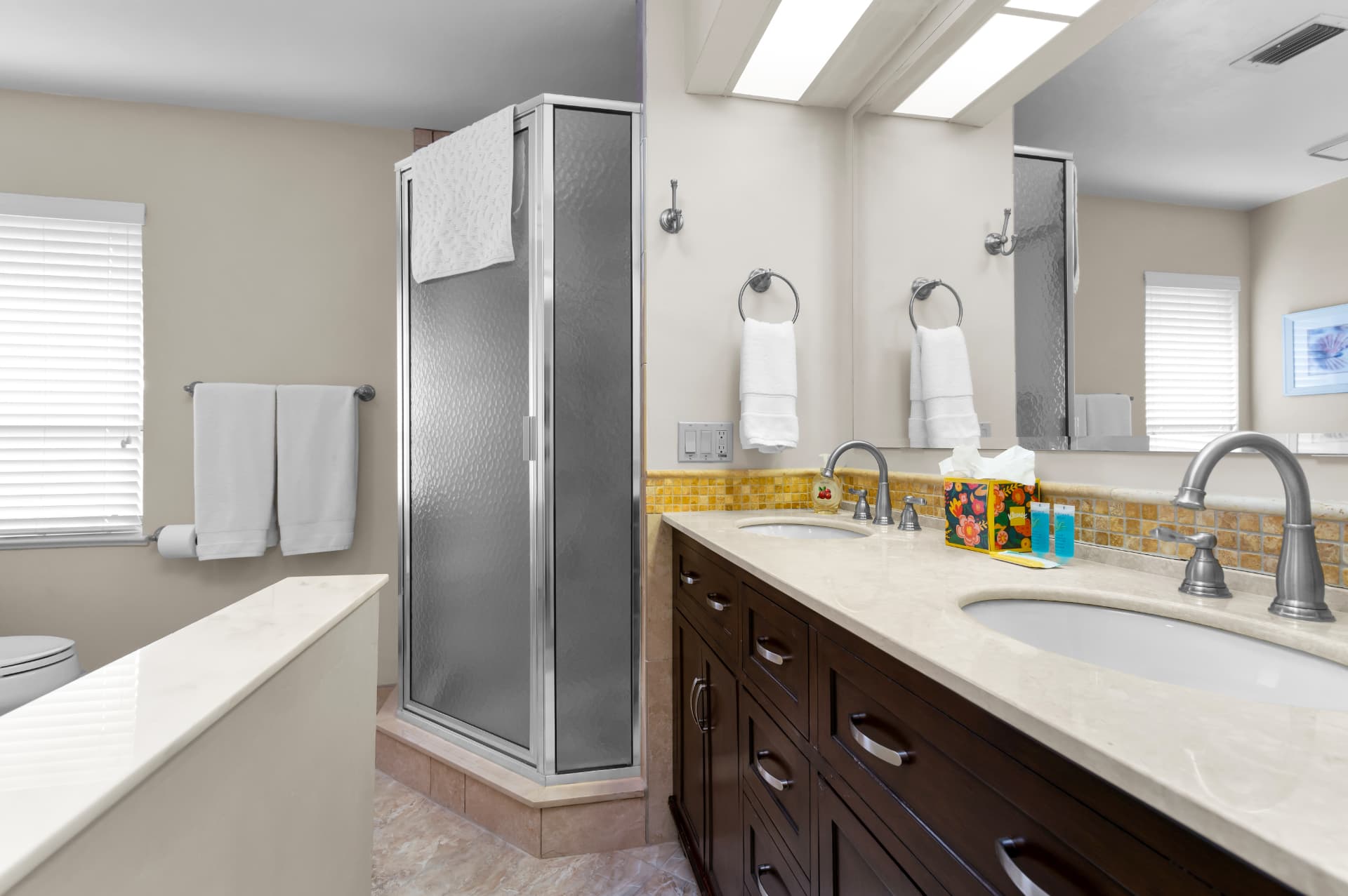 Primary bathroom with double vanity and walk-in shower at Pirates Cove Marco Island