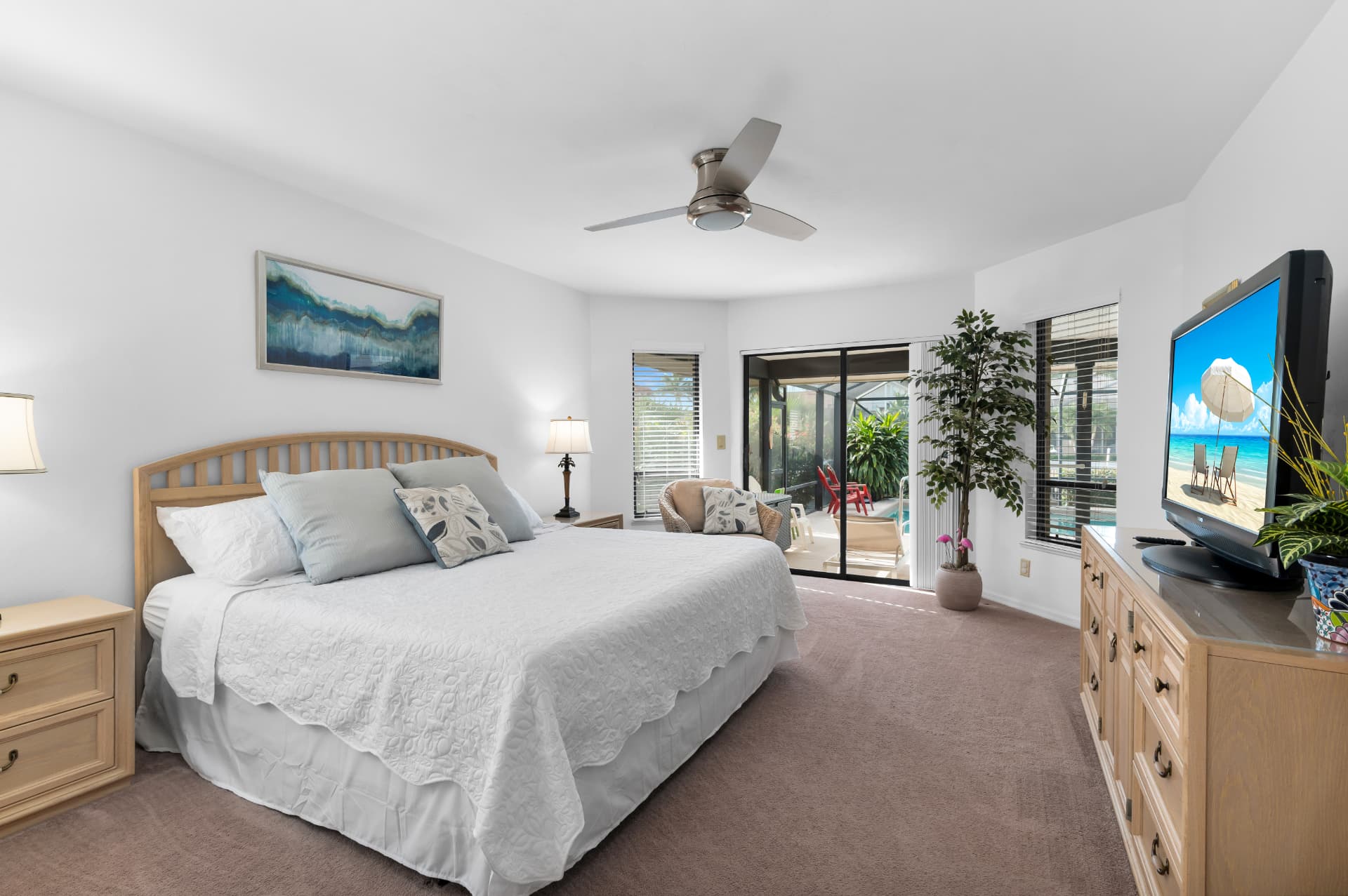 Primary bedroom with king bed and pool access at Pirates Cove Marco Island
