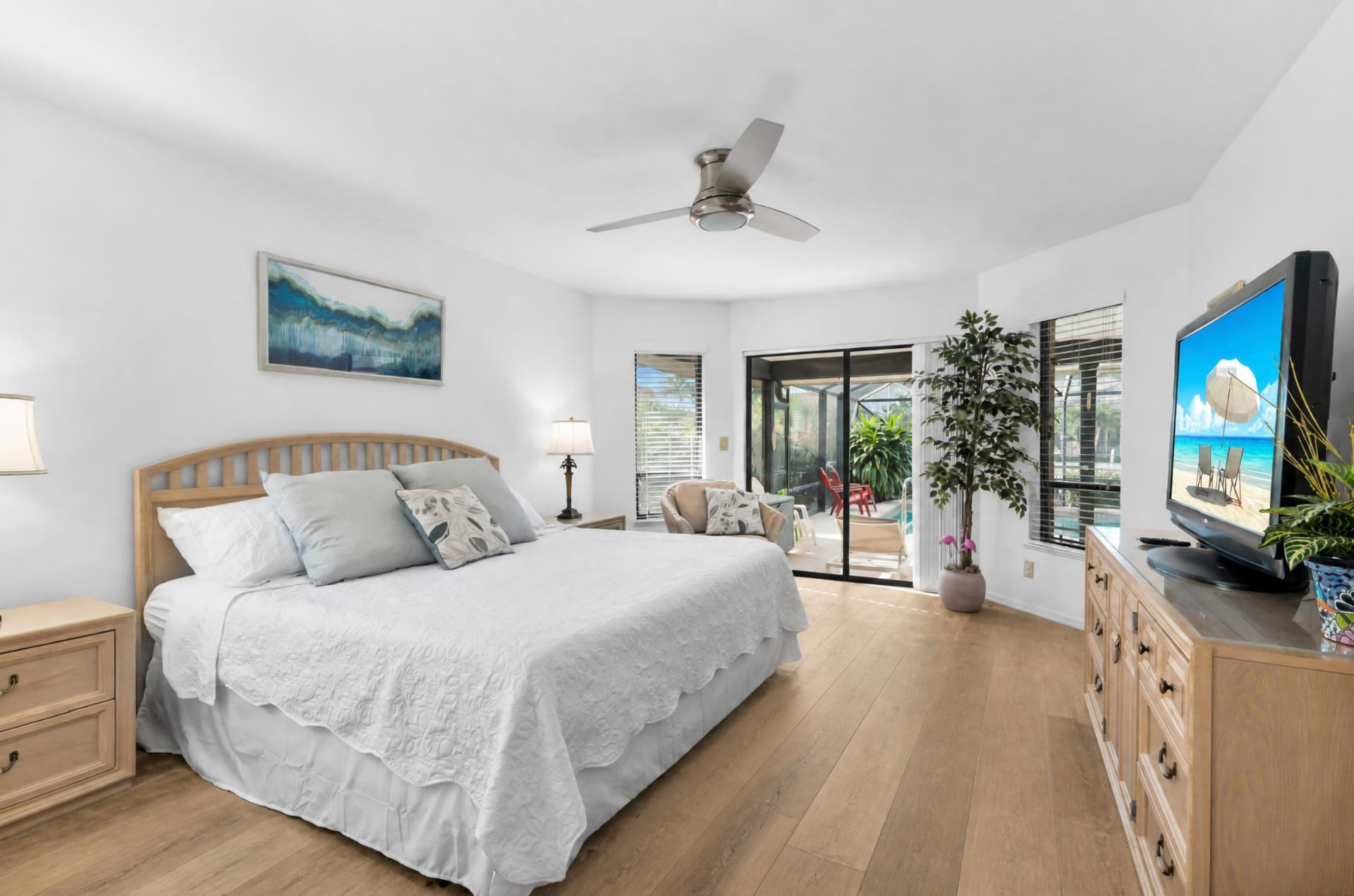 Primary bedroom with king bed and pool access at Pirates Cove Marco Island