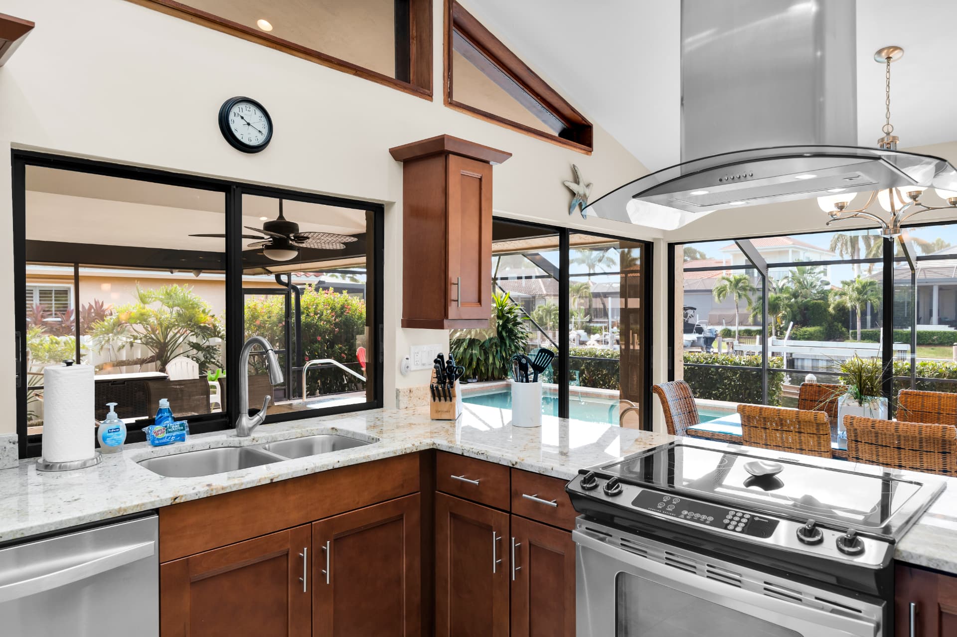 Kitchen sink and range with pool view at Pirates Cove Marco Island